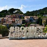 Charming hillside view of Bormes-les-Mimosas village with colorful houses in France.