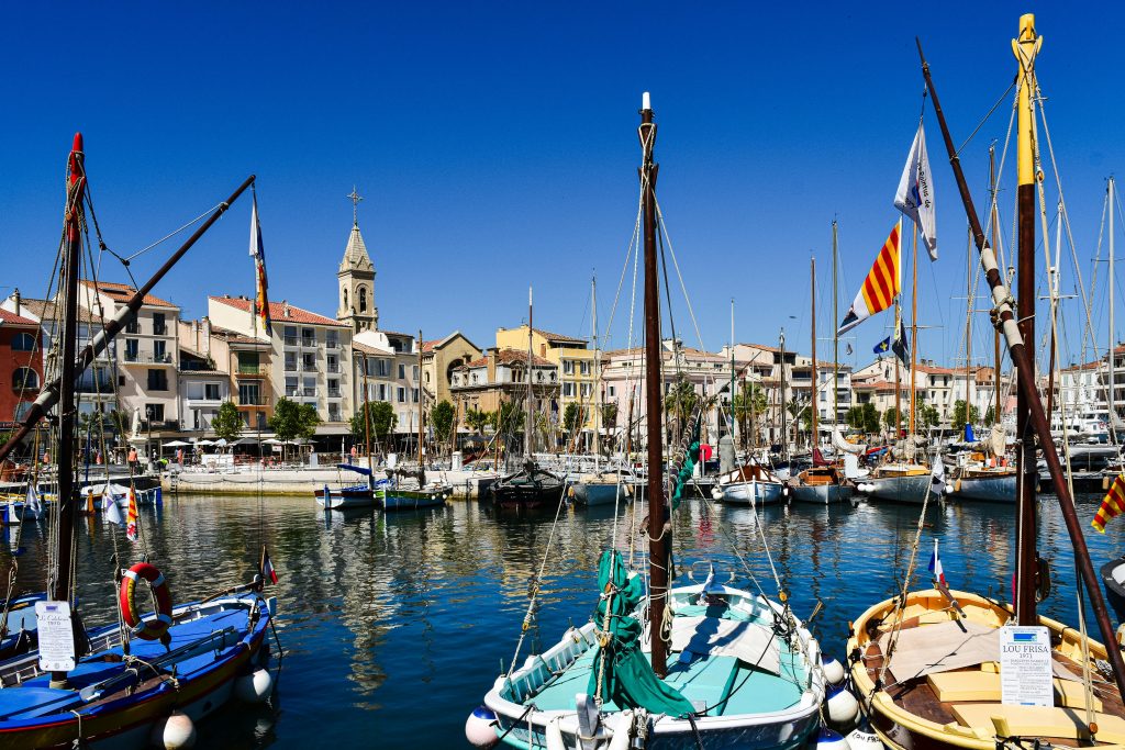 Scenic view of a vibrant harbor with boats and architecture in Provence-Alpes-Côte d'Azur, France.
