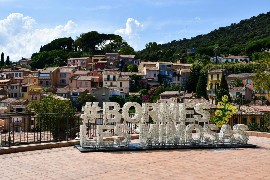 Charming hillside view of Bormes-les-Mimosas village with colorful houses in France.